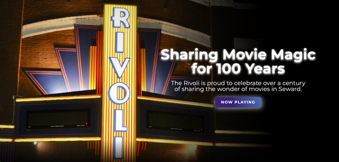 A sign for the rivoli theater says sharing movie magic for 100 years