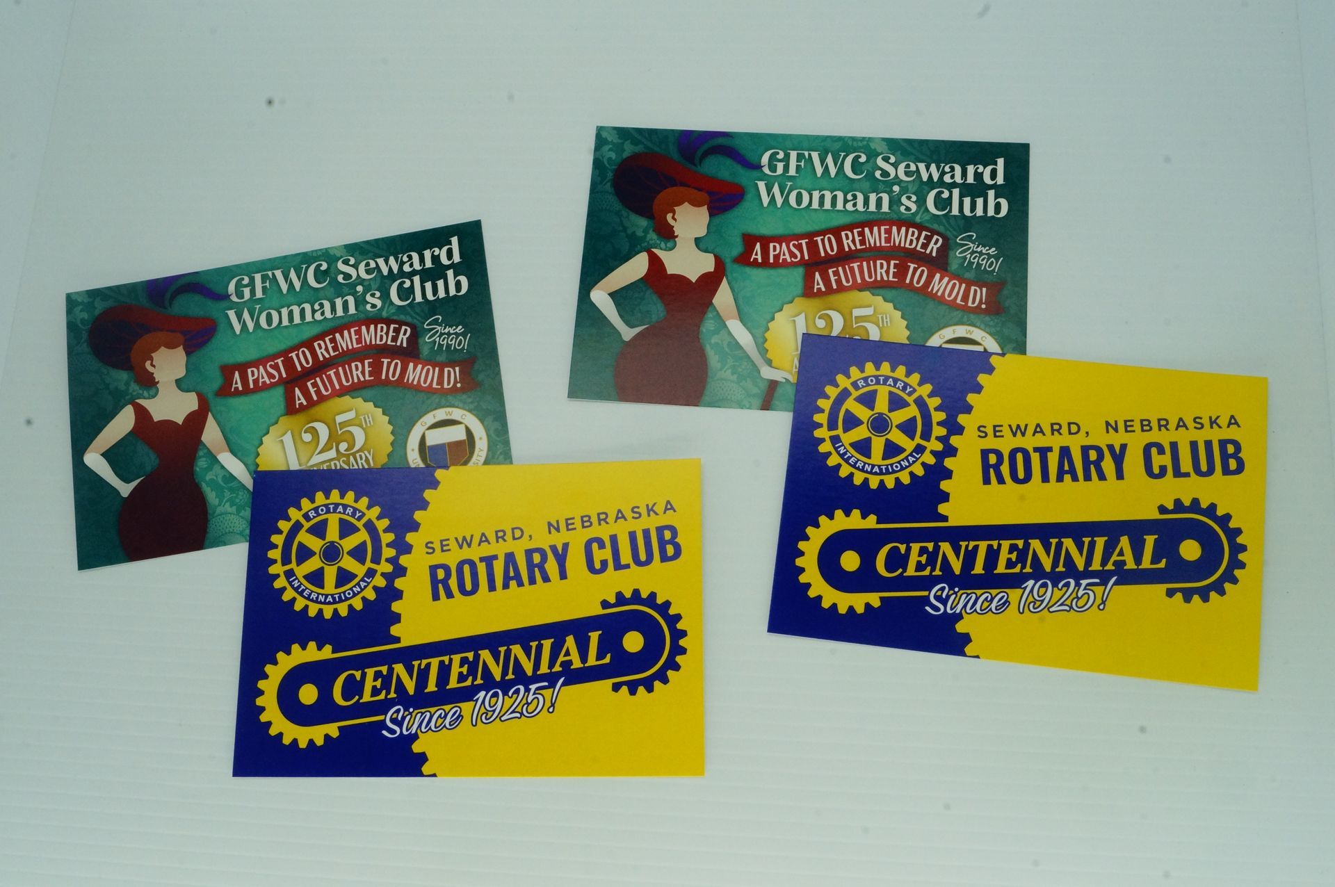 Four rotary club cards are on a table