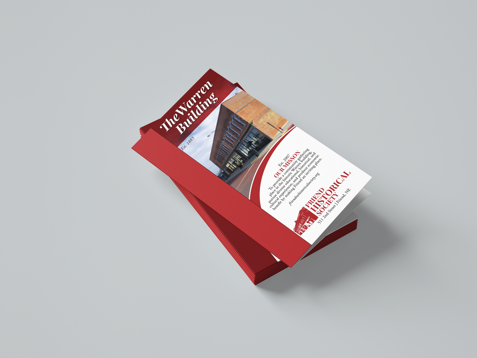 A red brochure with a picture of a building on it.