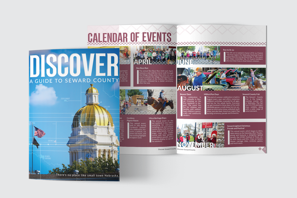A calendar of events for seward county is sitting on a table.