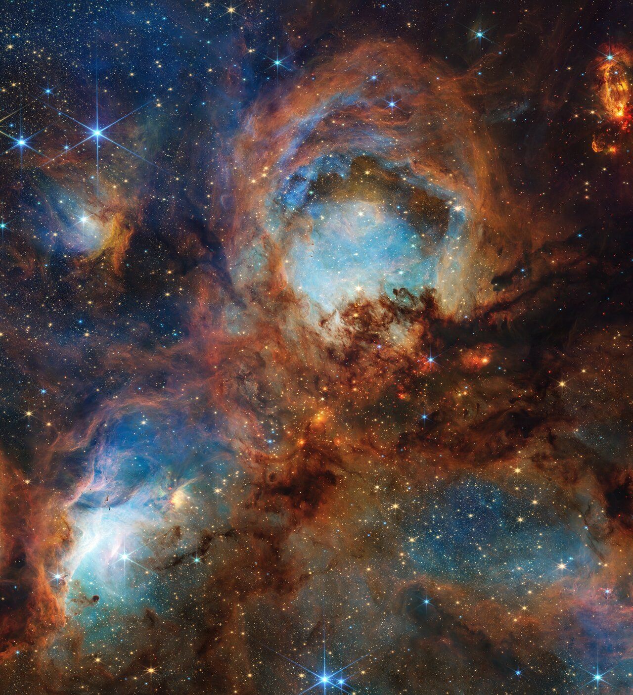 Nebula with swirling orange and blue gas clouds and stars.