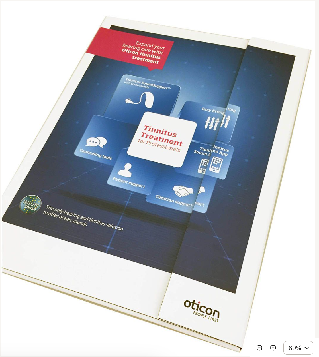 A brochure for oticon is sitting on a table