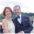 A bride and groom are posing for a picture on their wedding day.