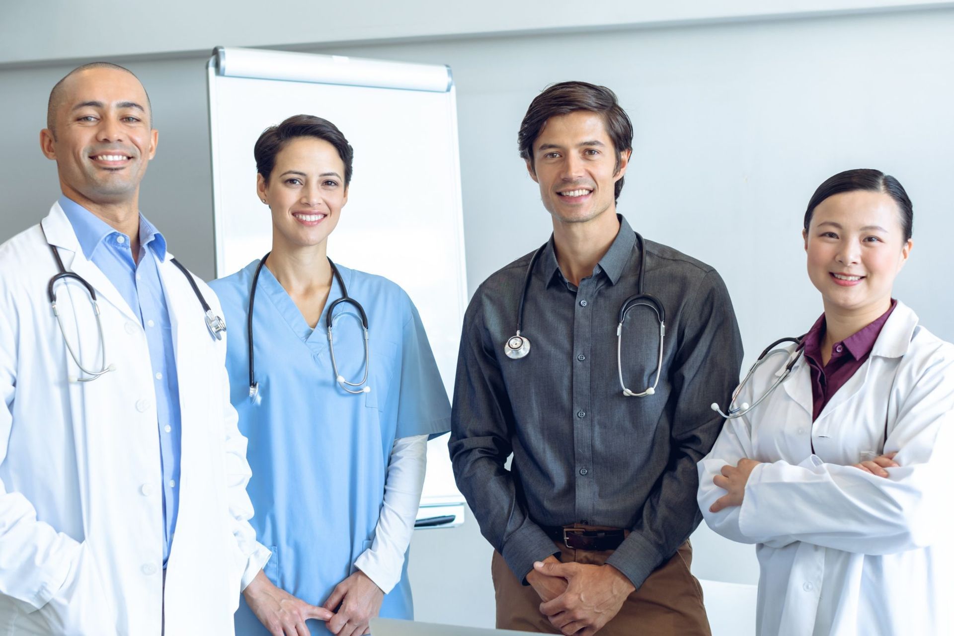 A group of doctors and nurses are posing for a picture.