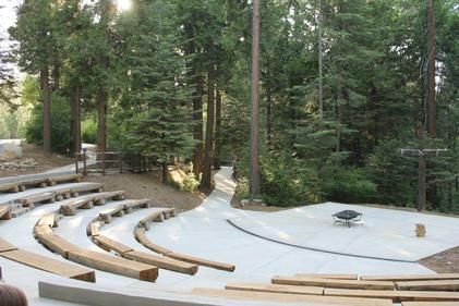 A wooden amphitheater in the middle of a forest