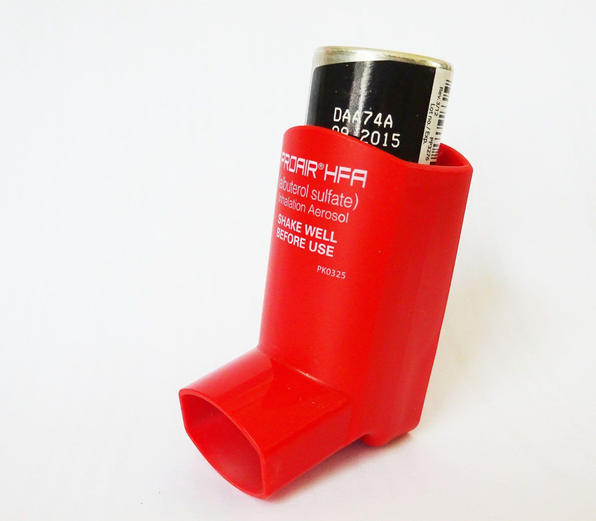 A red inhaler with a black can in it