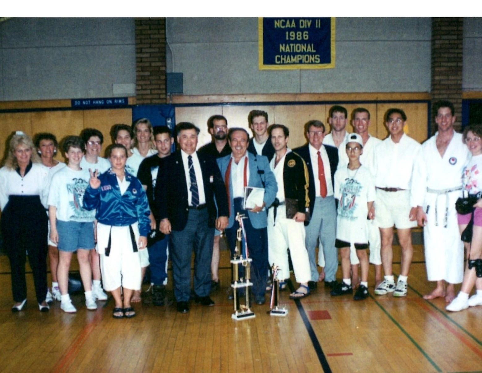 A group of people posing in front of a sign that says ncaa div 1