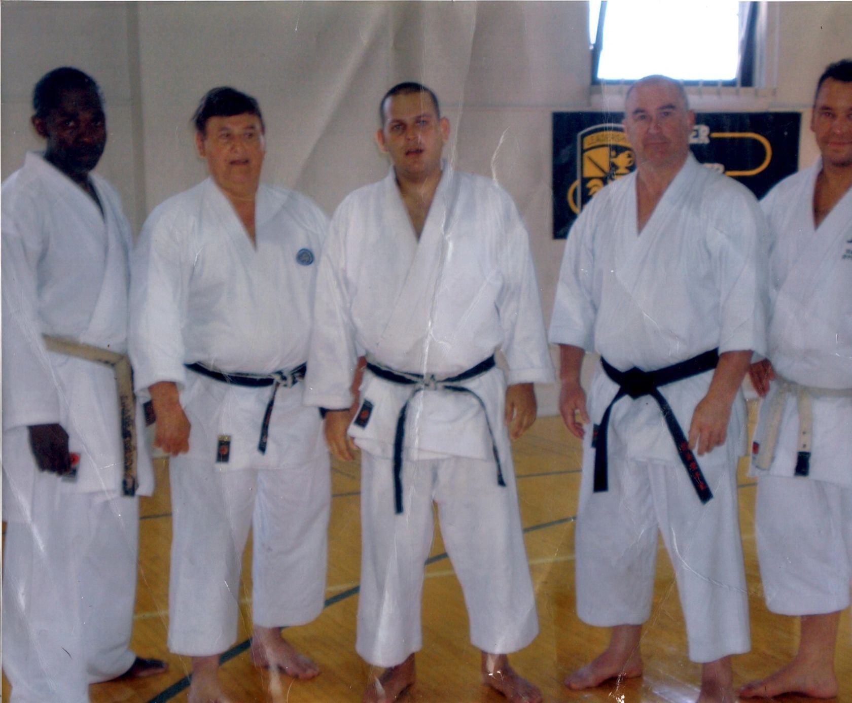 A group of men in karate uniforms pose for a picture