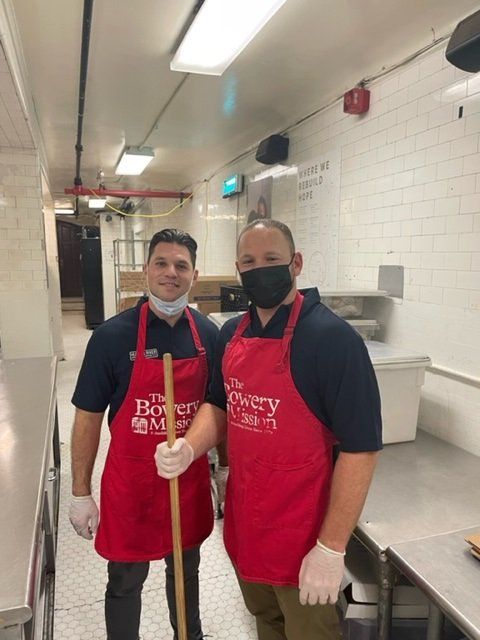 two hudson river moving employees wearing aprons