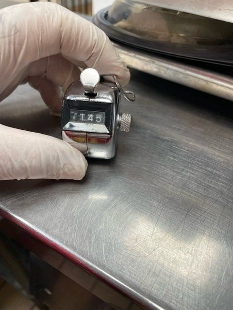 person holding attendance clicker with number 145