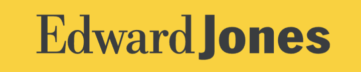 A woman wearing sunglasses is smiling while sitting in a car.