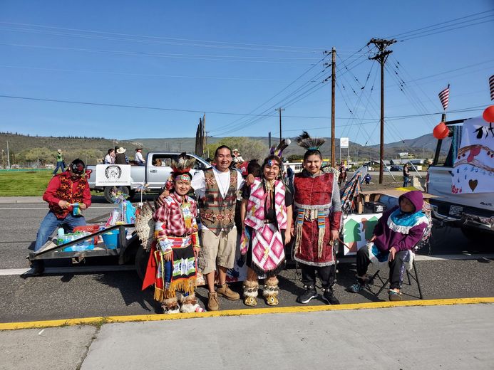 A group of people are posing for a picture on the side of the road.