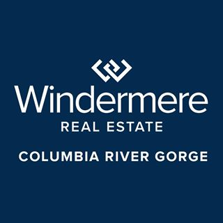 A man in a suit and white shirt is smiling for the camera.