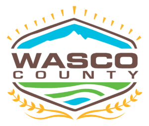 A logo for wasco county with a mountain in the background