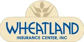 A woman in a black jacket and blue shirt is smiling for the camera.