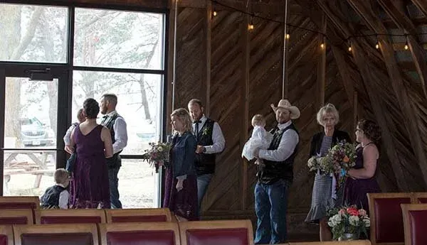 Wedding party inside a rustic building
