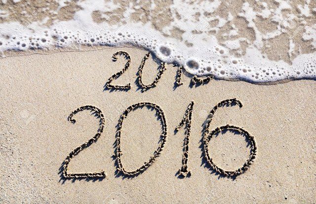 Wave washing away 2015 revealing 2016 written in the sand