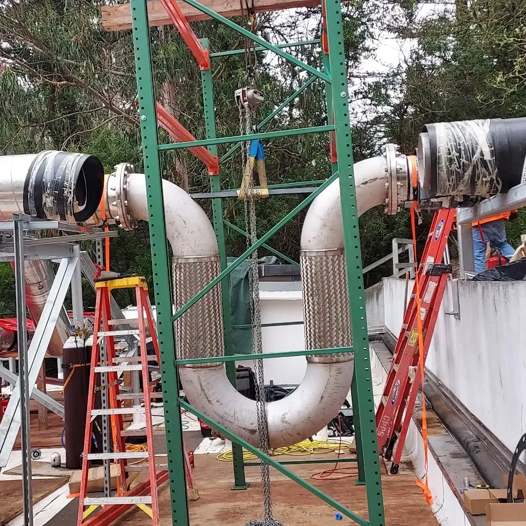 A green scaffolding with pipes attached to it