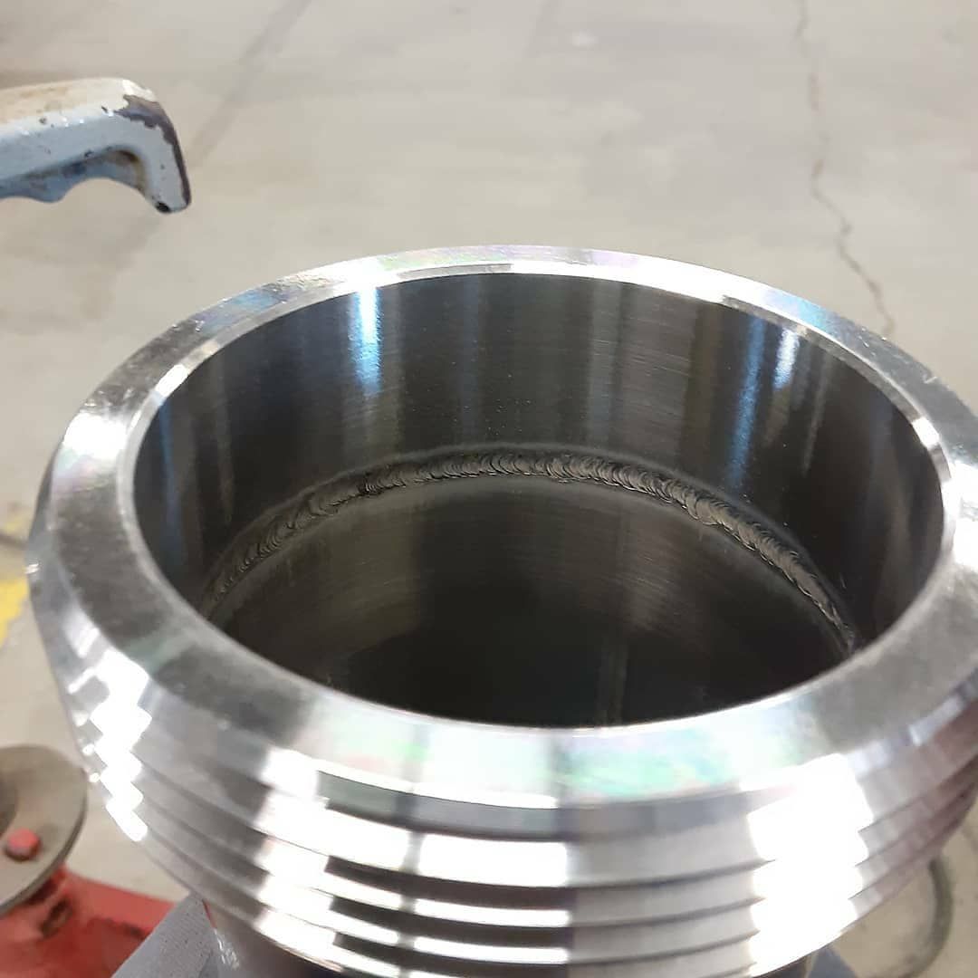 A close up of a metal object with a handle on it