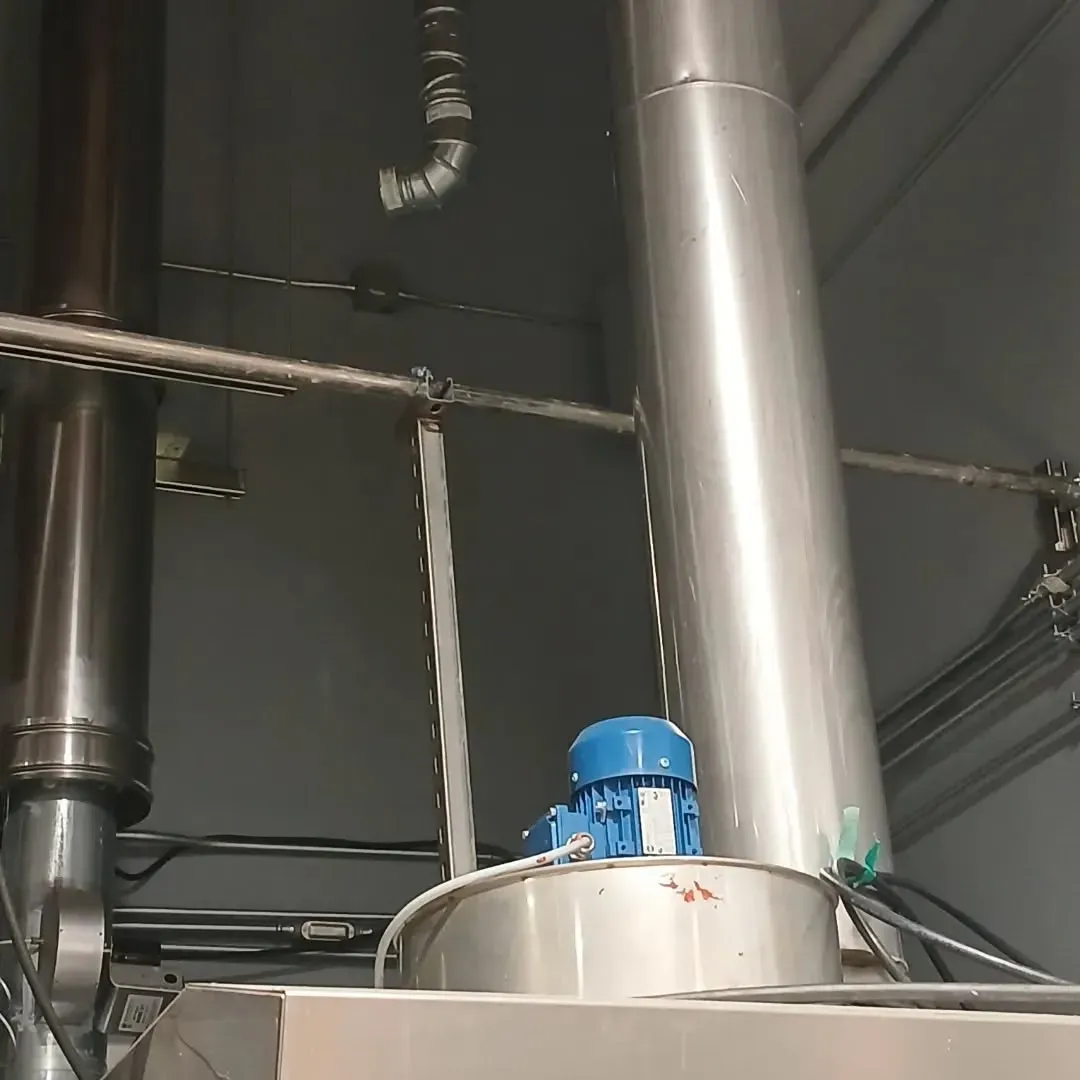 A stainless steel pipe with a blue motor on top of it