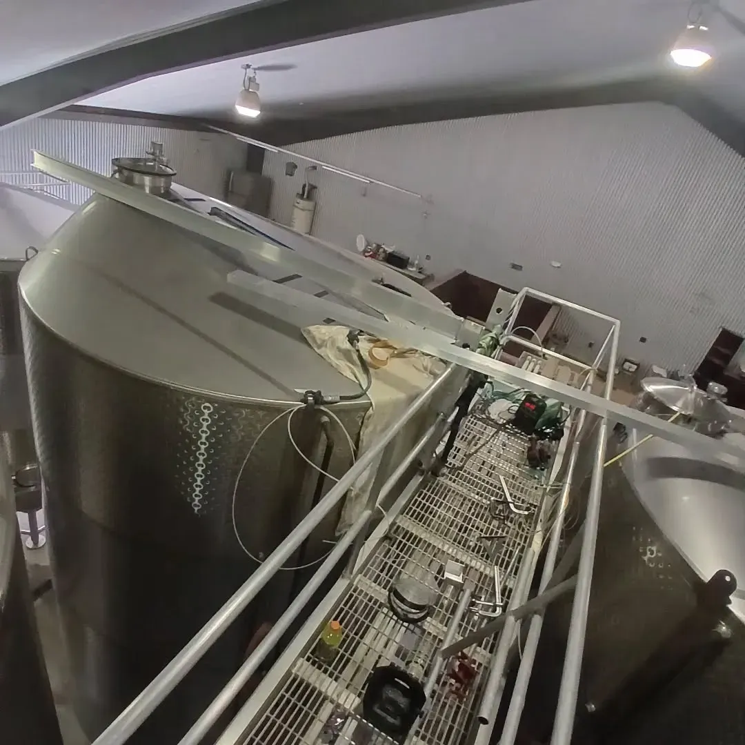 A large stainless steel tank in a factory
