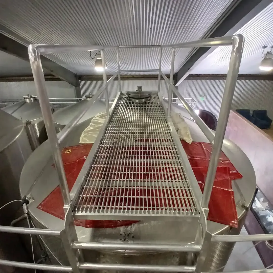 A metal staircase leading up to a large metal tank