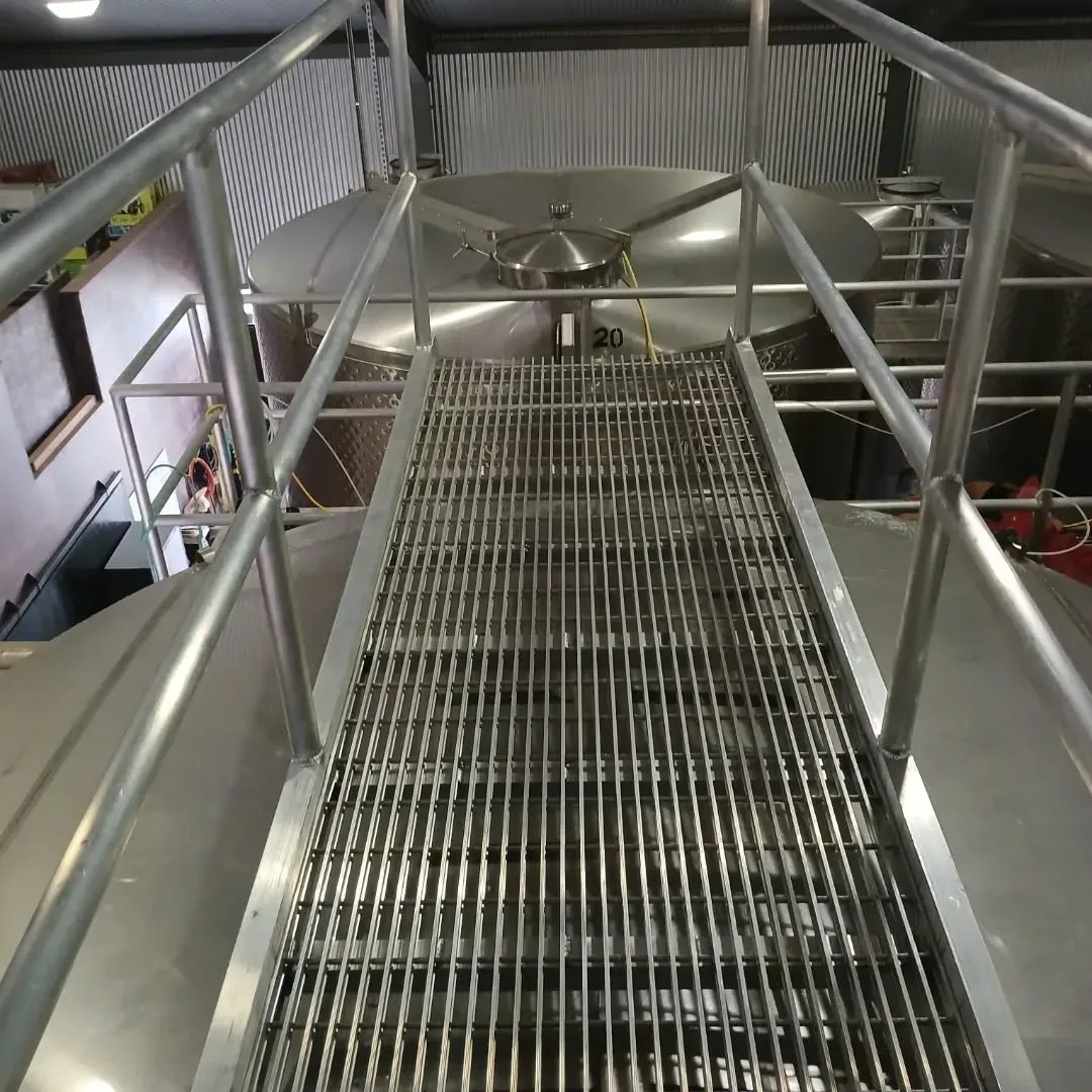 A metal staircase in a building with a railing