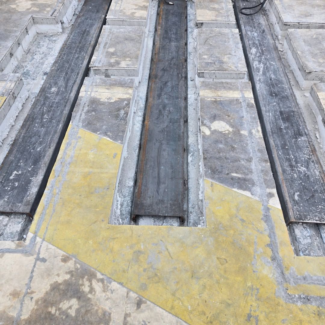A concrete floor with a yellow arrow on it