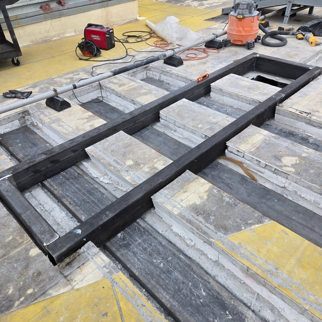 A large metal frame is sitting on top of a concrete floor.