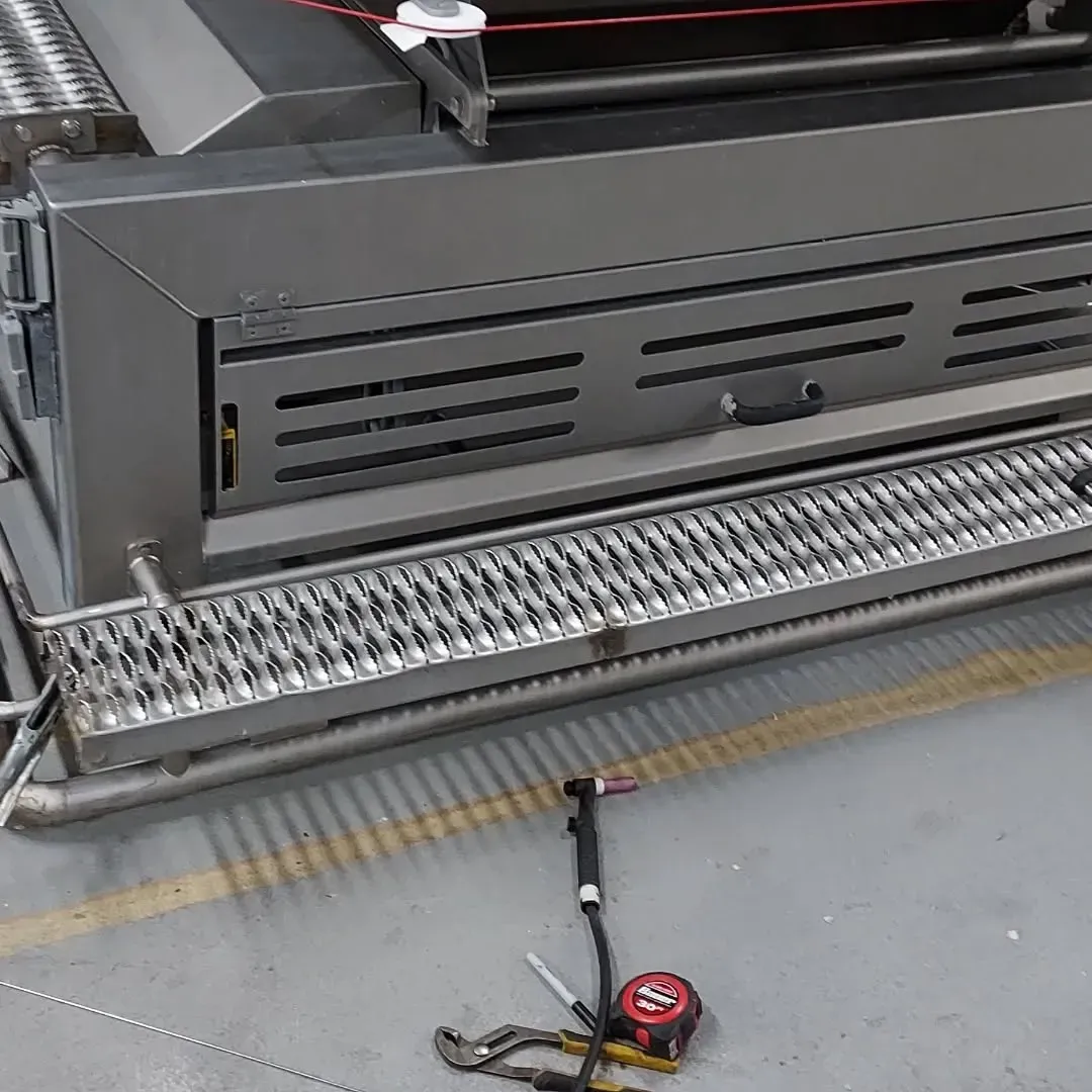 A tape measure is laying on the ground next to a machine