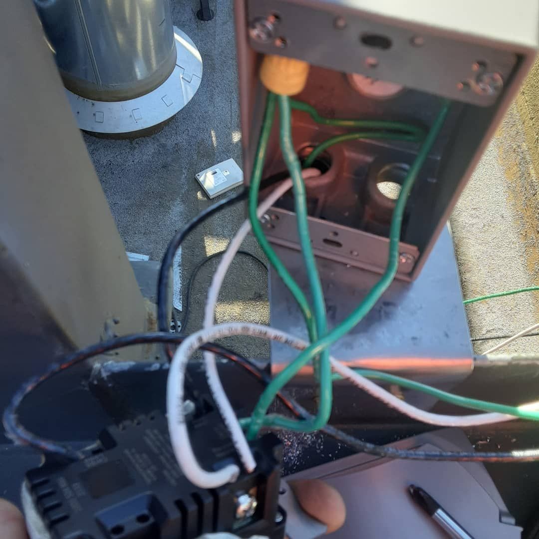 A bunch of wires are coming out of a box.