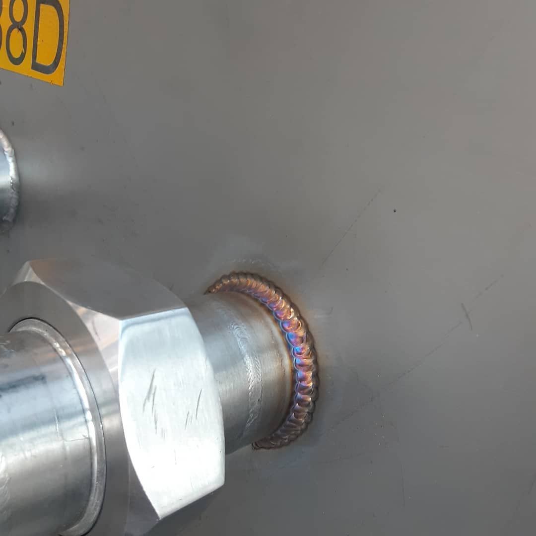 A close up of a metal pipe with a screw on it.