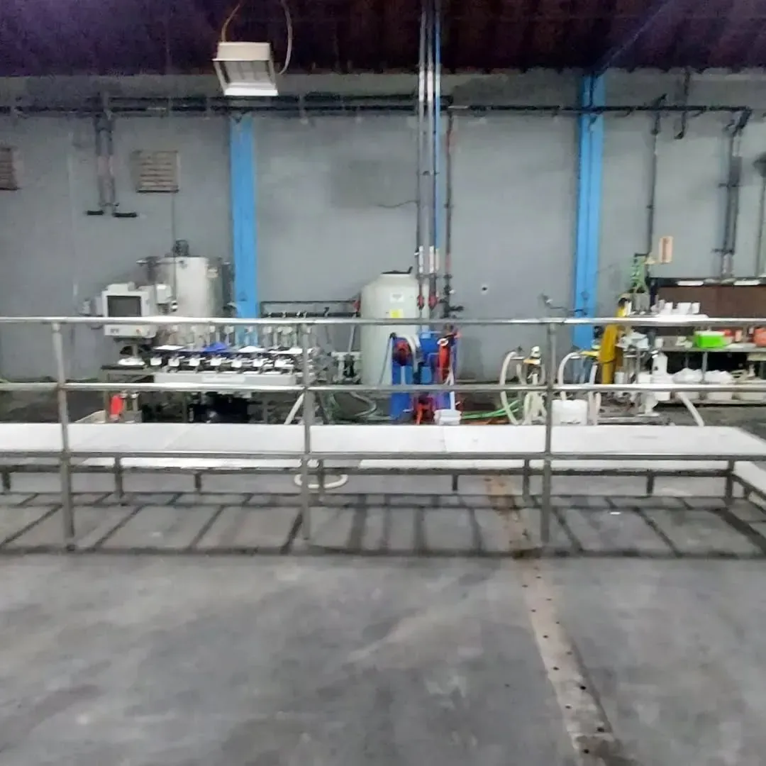 A row of benches in a warehouse with a metal railing