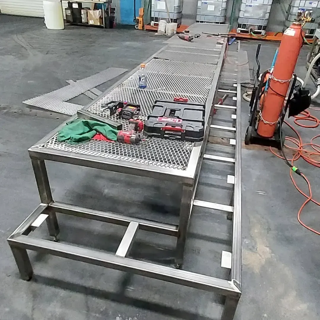 A stainless steel table with tools on it in a workshop.