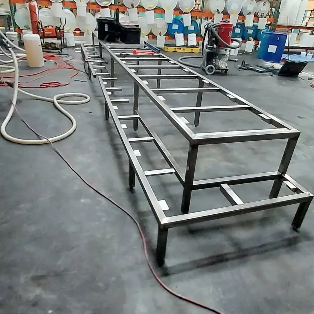 A long metal ladder is sitting on the floor in a factory.