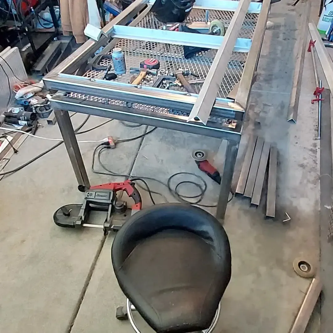 A chair is sitting in front of a table with a lot of tools on it.