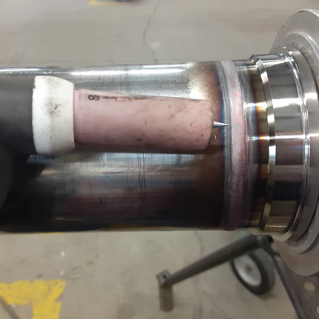 A close up of a metal pipe with a white cap on it