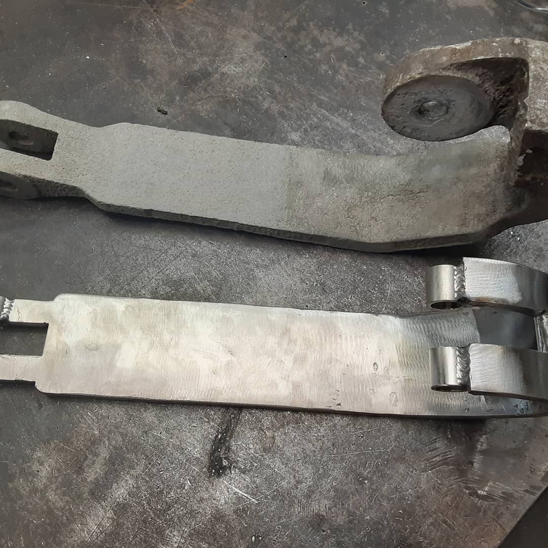 Two metal pieces are sitting on top of each other on a table.