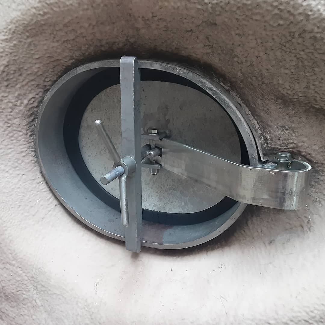 A close up of a round metal object on a wall