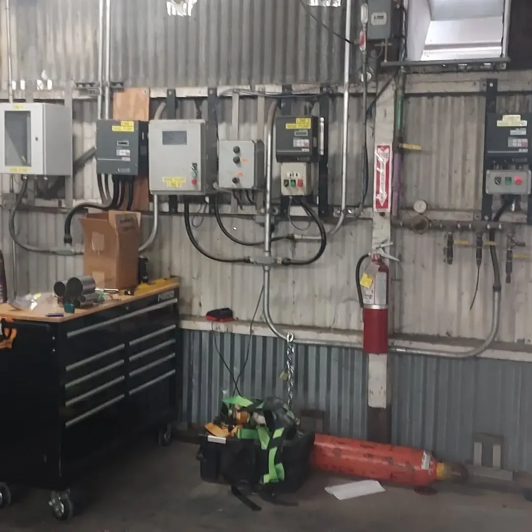 A room with a lot of electrical equipment and a fire extinguisher