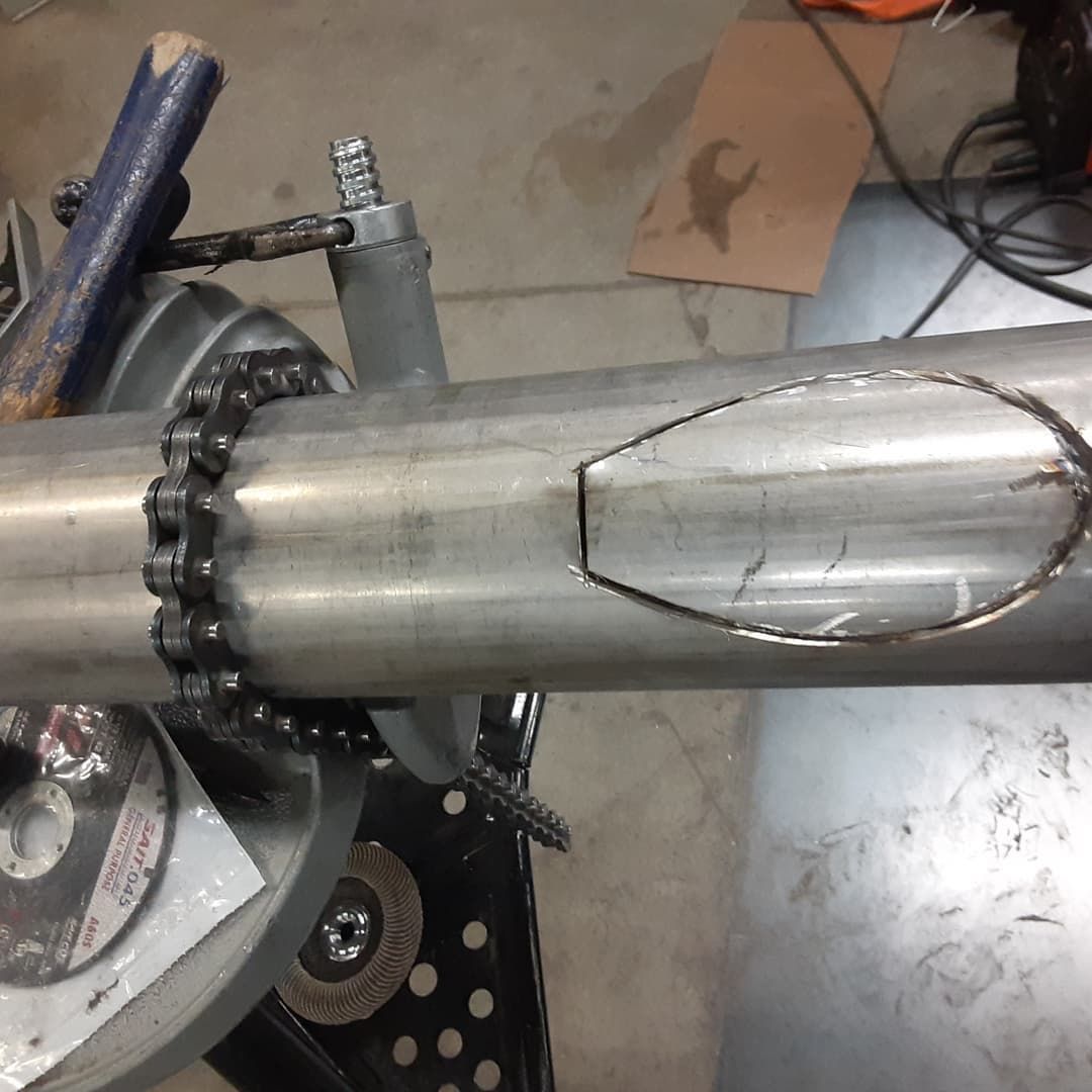 A metal pipe with a hole in the middle of it