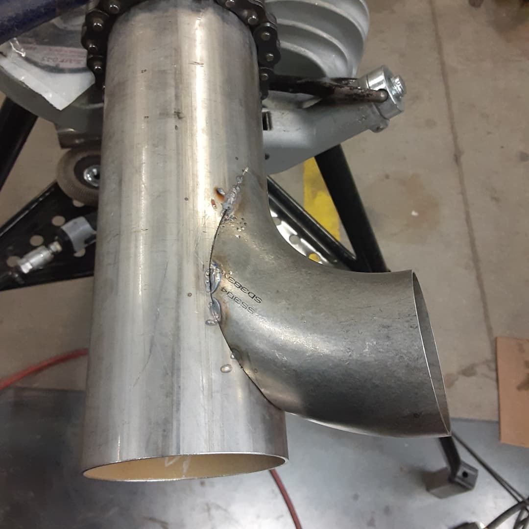 A stainless steel pipe is sitting on a table