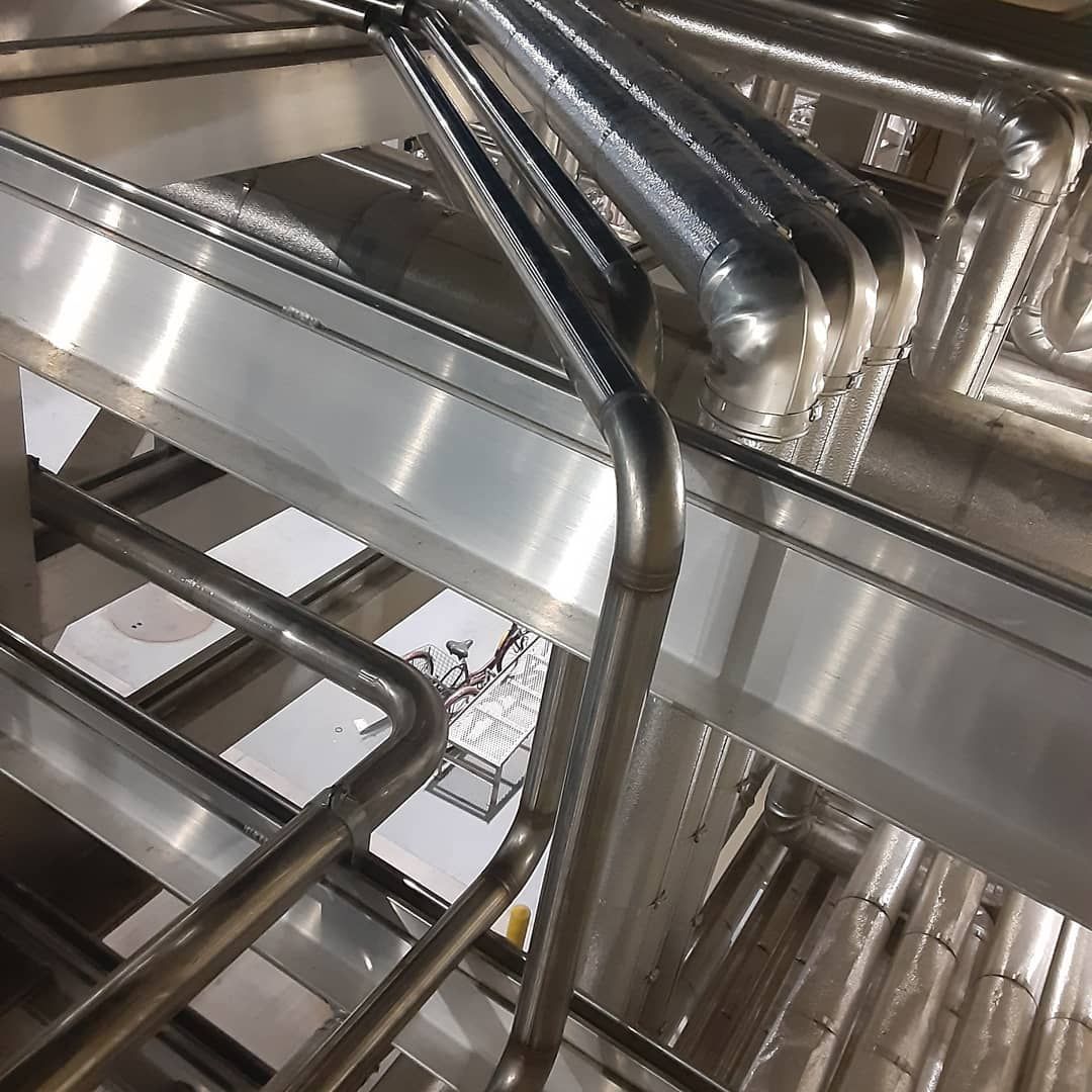 A close up of a metal structure with stairs and pipes