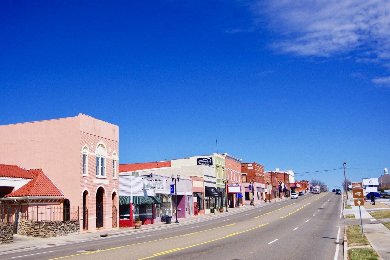 A row of buildings on the side of a road