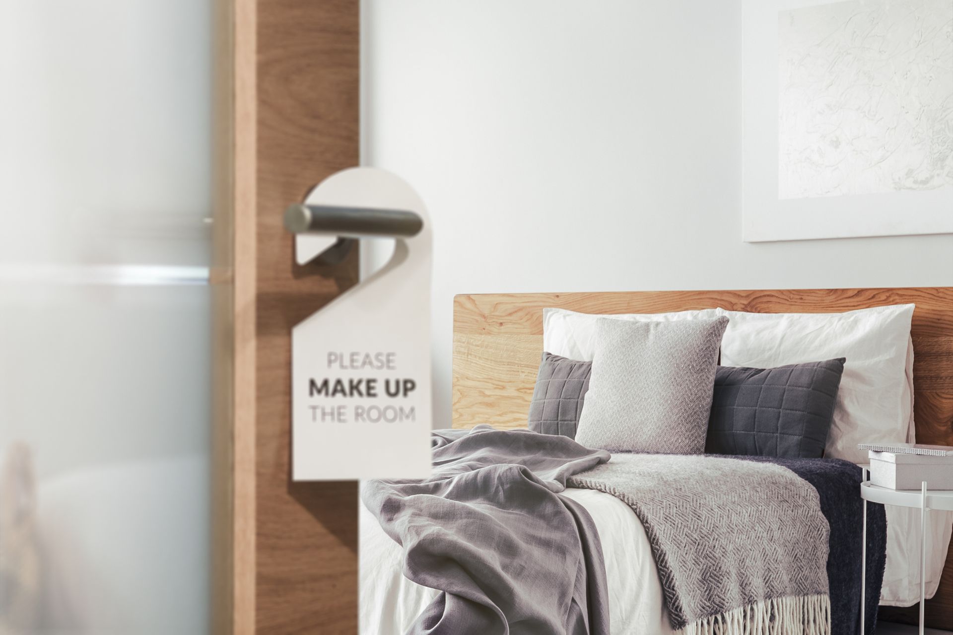 hotel room with a make up room sign on the door