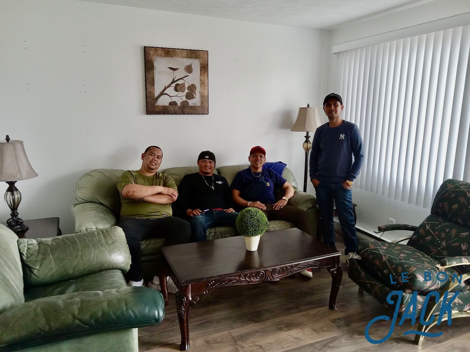 Un groupe d'hommes sont assis sur un canapé dans un salon.