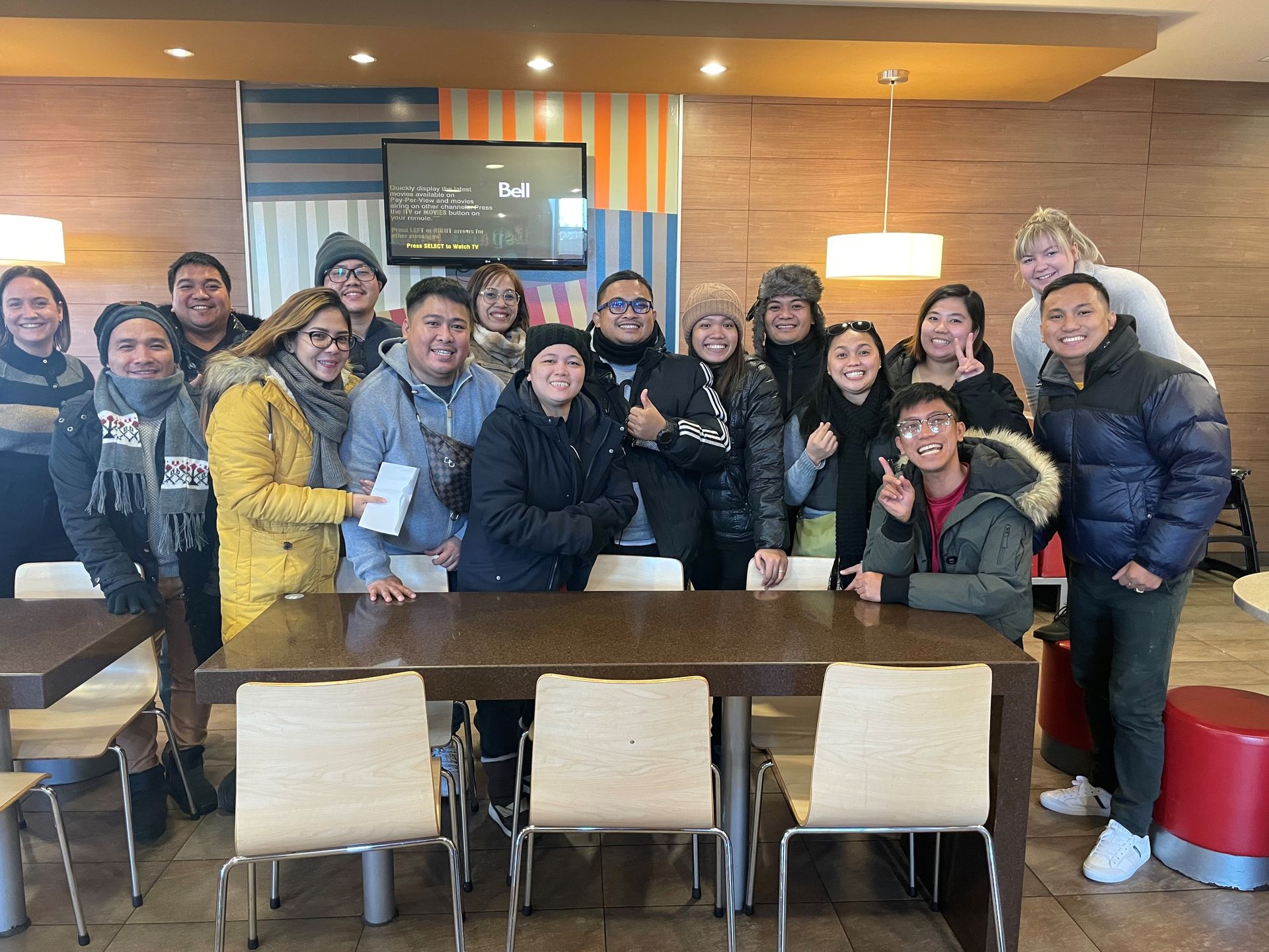 Un groupe de personnes pose pour une photo dans un restaurant.
