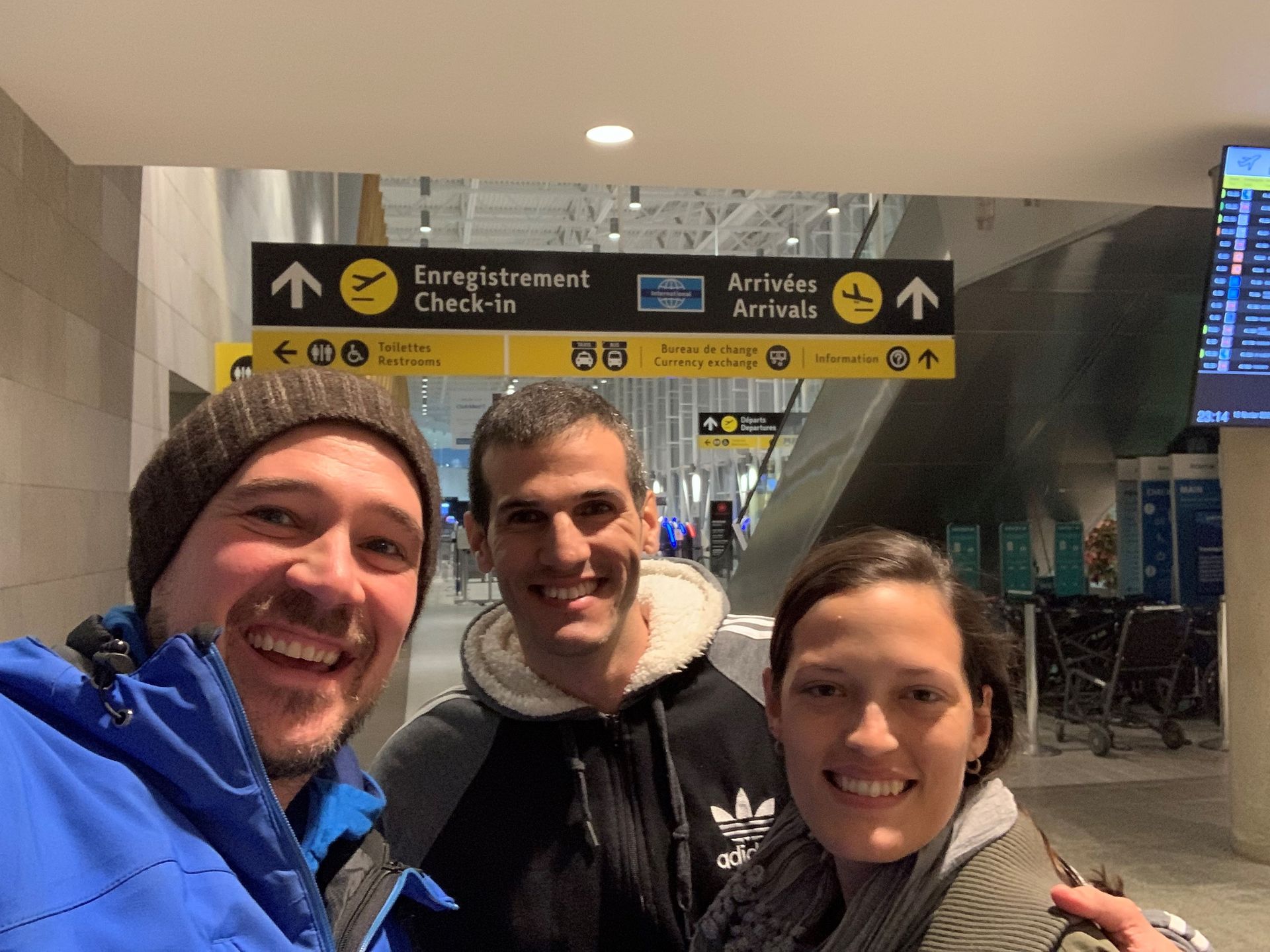 Un groupe de personnes pose pour une photo dans un aéroport.