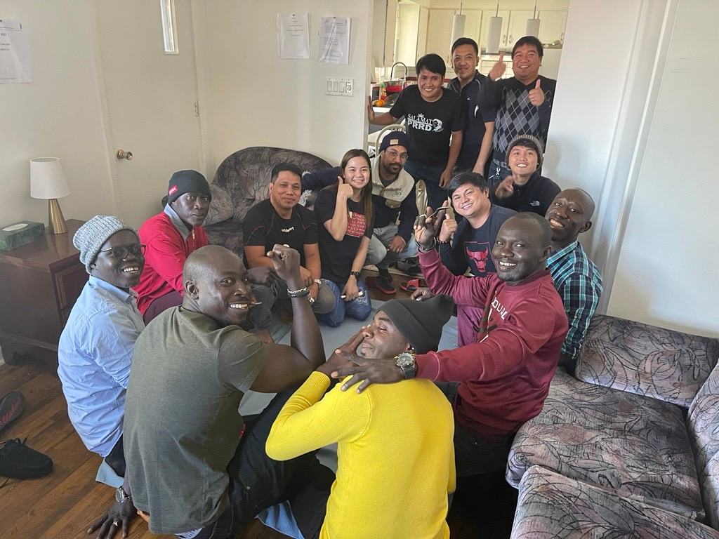 Un groupe de personnes pose pour une photo dans un salon.