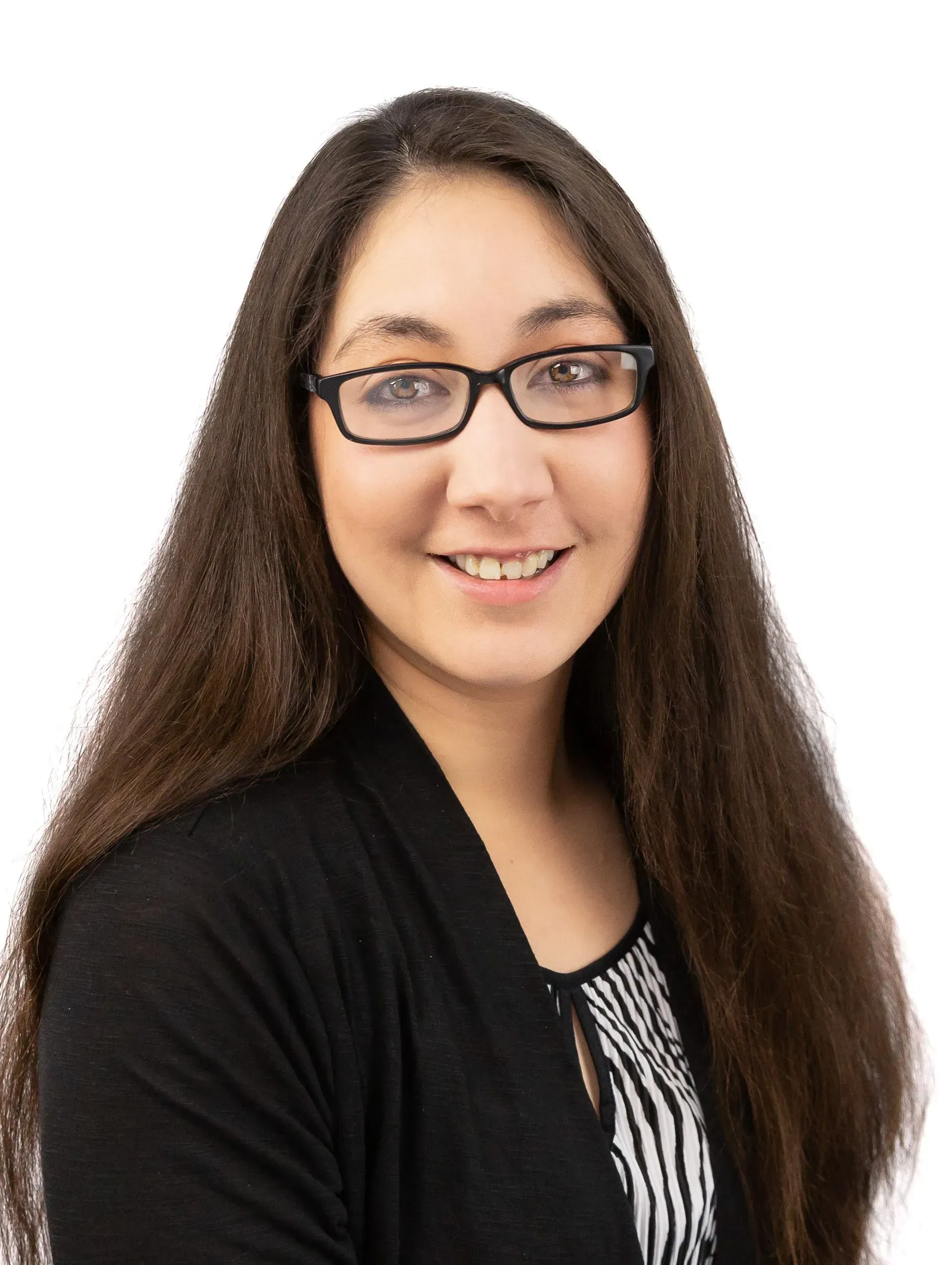 A woman with long hair and glasses is smiling for the camera.